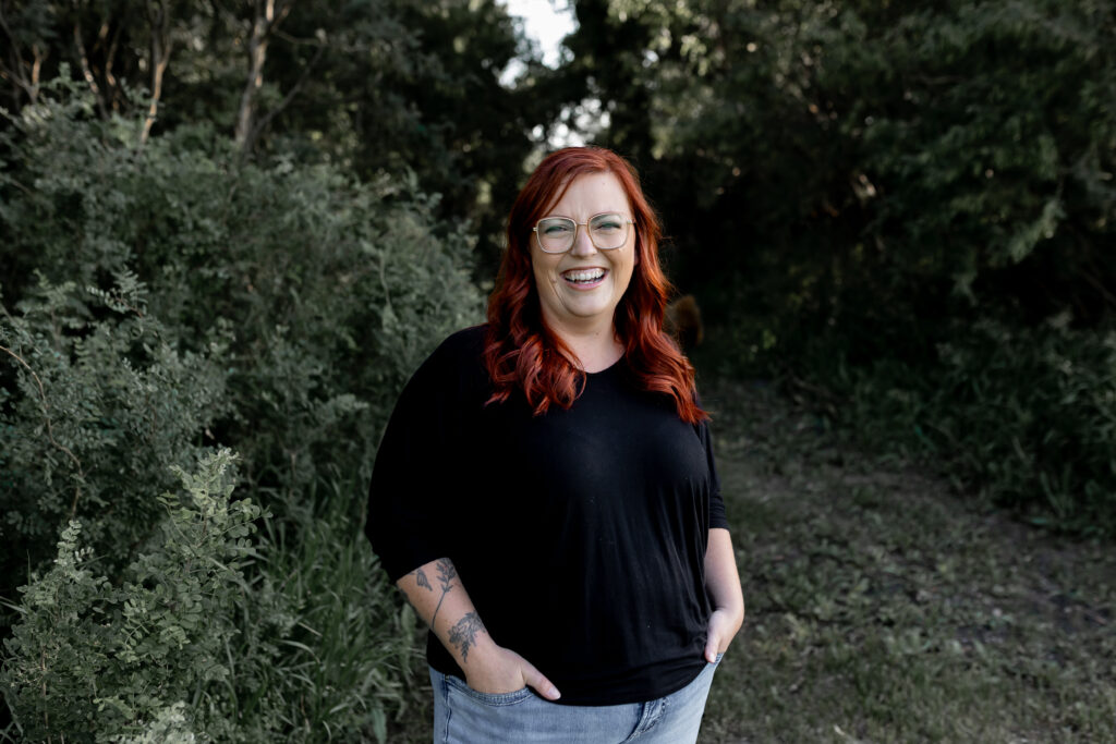 Smiling red haired women standing in the trees